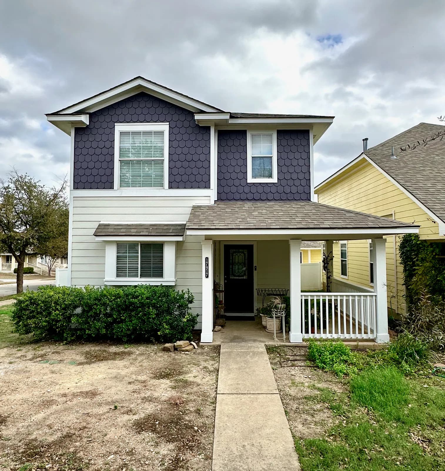 Two-story home freshly repainted in deep navy and white by Ranger Painting in Round Rock