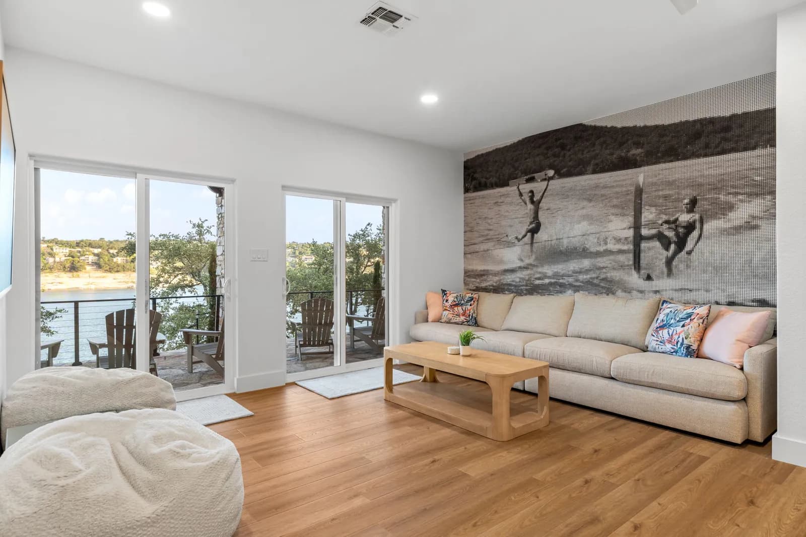 Bright lakeview living room with clean white painted walls and a beige sofa by Ranger Painting in Austin