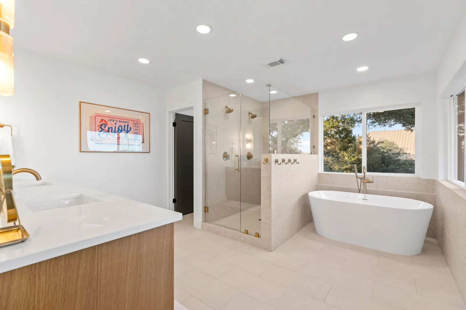 Bright white spa bathroom with a freestanding soaking tub painted by Ranger Painting near Lakeway