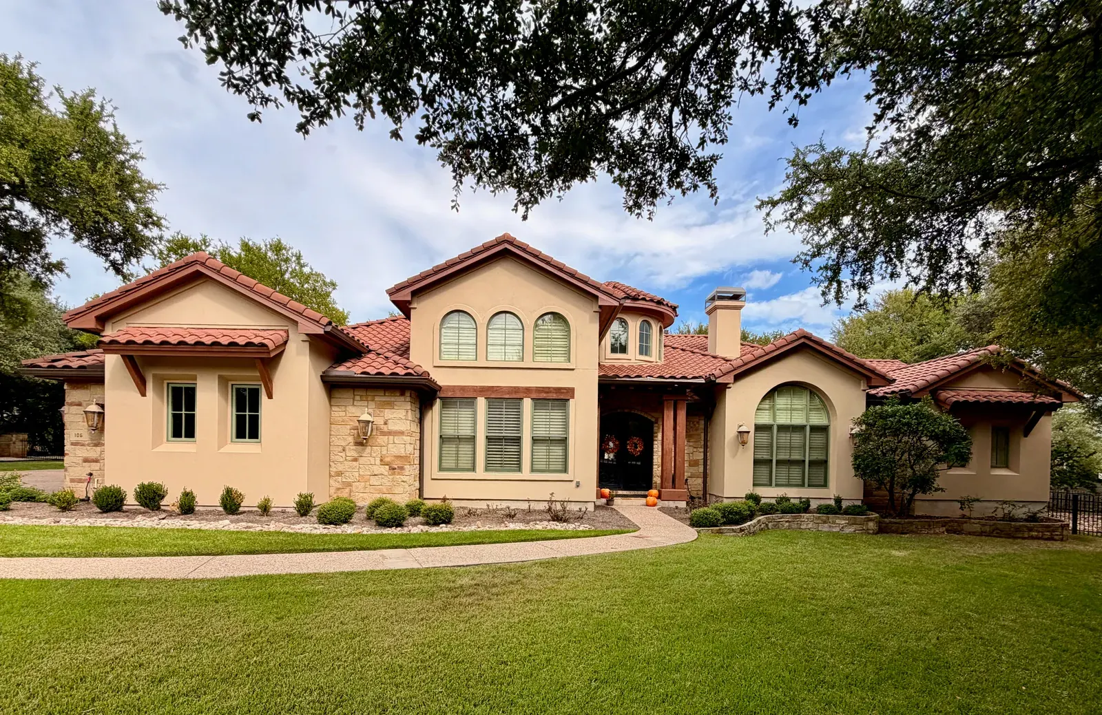 Stucco house painting with Mediterranean clay tiles